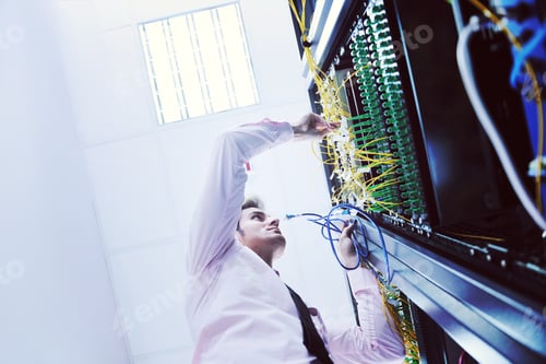 Preview: young it engeneer in datacenter server room