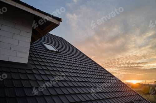 Preview: Closeup of house roof top covered with ceramic shingles. Tiled covering of building