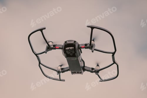 Preview: Black drone against a cloudy sky, close-up