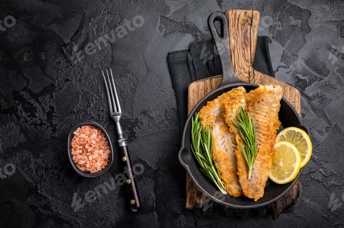 Preview: Pan Fried Hake white fish fillet. black background. top view