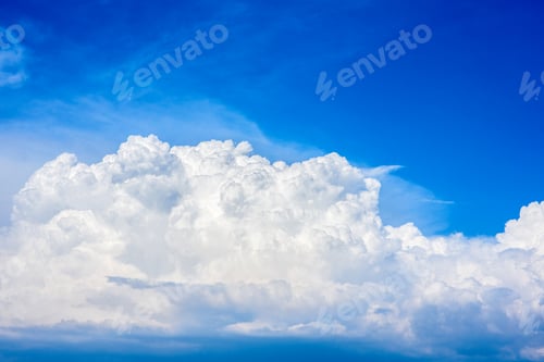 Preview: Beautiful white clouds in a bright blue sky on a warm summer day