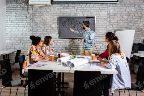 Preview: Group of modern business people in casual wear discussing architectural designs in the office.
