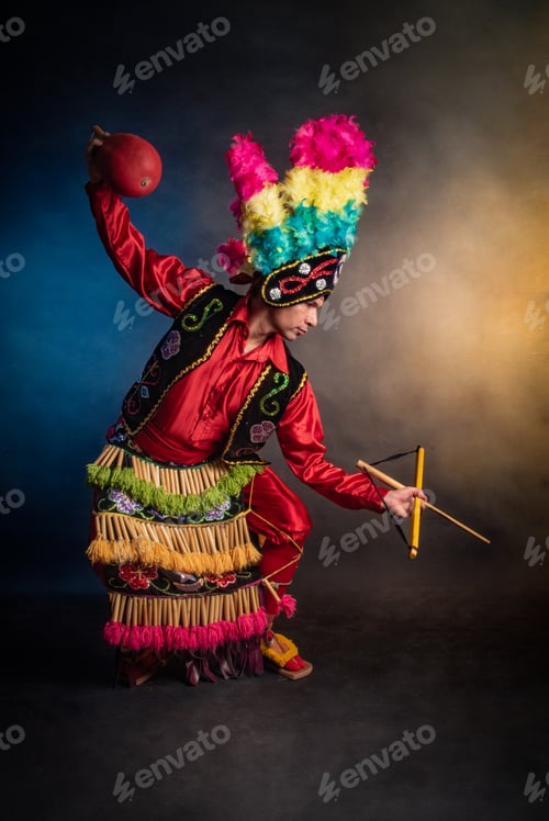 Preview: Matlachines Dancer from Coahuila Mexico A man in a colorful costume is holding a ball and a stick