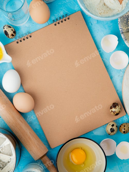 Preview: side view of foods as egg, egg yolk with water and rolling pin on blue background with copy space