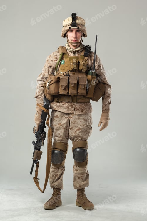 Preview: Soldier stands in full combat gear with weapon and communication device in a neutral setting