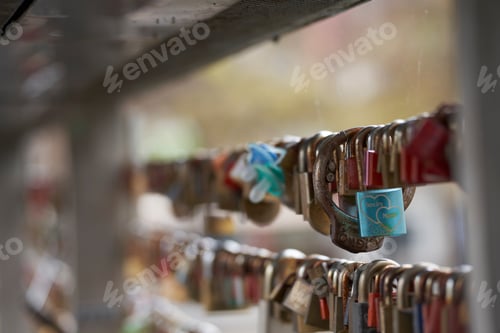 Preview: Selective focus shot of a bridge full of hanged padlocks for love