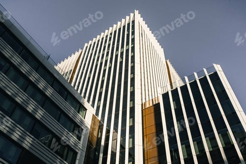 Preview: Low angle shot of high-rise buildings under a dark sky