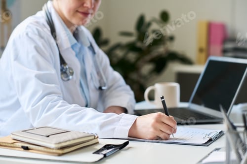 Preview: Professional Doctor Working in Office with Laptop