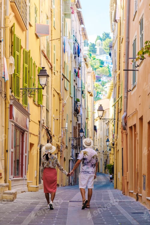 Preview: Menton France,couple men and woman on vacation at the Cote d Azur France, View on old part of Menton
