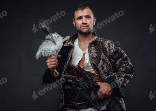 Preview: Handsome corsair dressed in pirate clothing holding hat