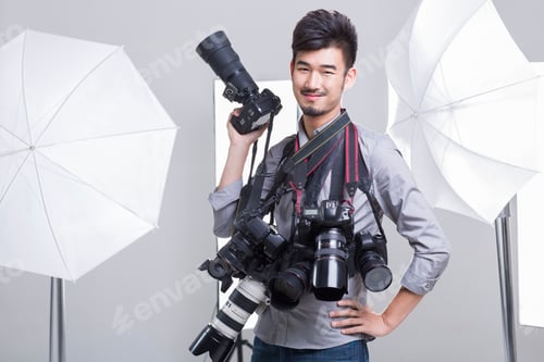 Preview: Portrait of photographer with many cameras hanging on his neck