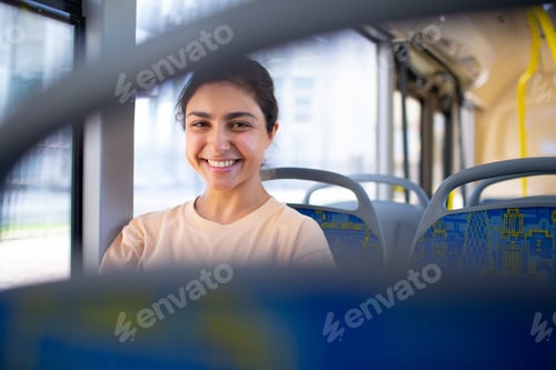 Preview: Smiling Woman Enjoying a Bus Ride in City
