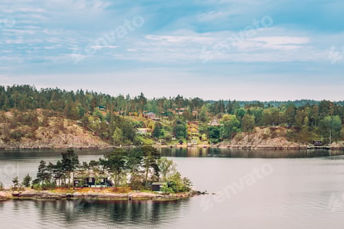 Preview: Sweden. Many Beautiful Swedish Wooden Log Cabins Houses On Rocky Island Coast In Summer Day. Lake Or