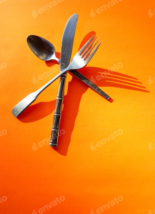 Preview: Silverware flat lay on orange