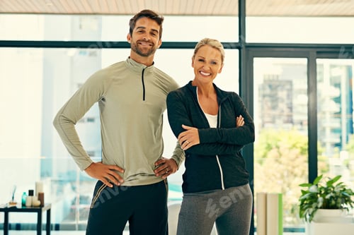 Preview: Portrait of two happy physiotherapists posing together in a fitness center