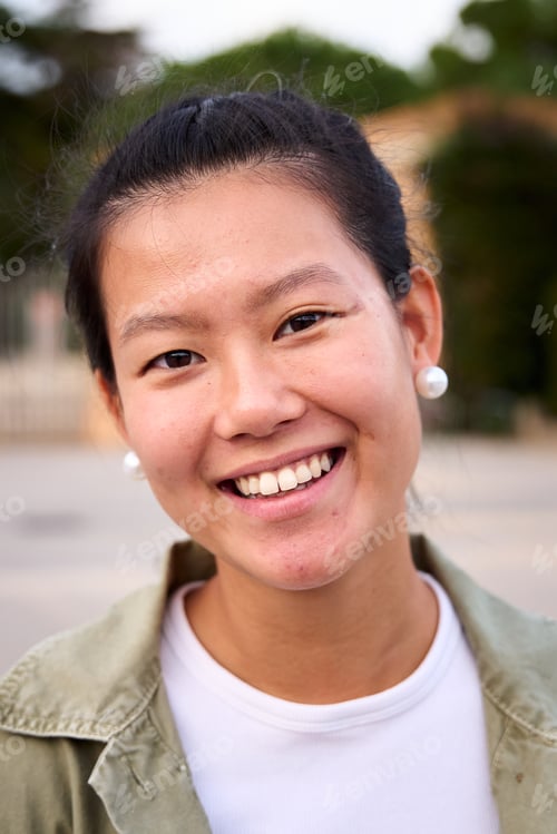 Preview: Close up portrait of happy beautiful young Asian woman happy smiling face on street. Female people.