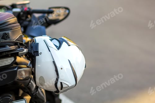 Preview: Helmet on sports motorcycle on road. Motorbike parked on a street. Freedom and travel concept.