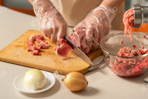 Preview: female hands cutting meat for minced meat