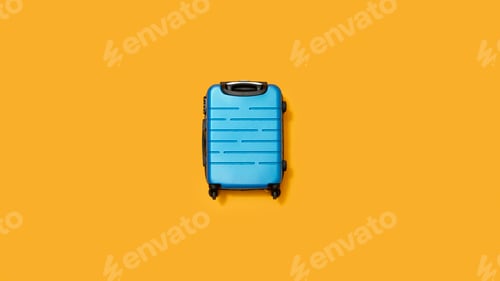 Preview: Flat Lay Shot Of Blue Holiday Suitcase On Yellow Background