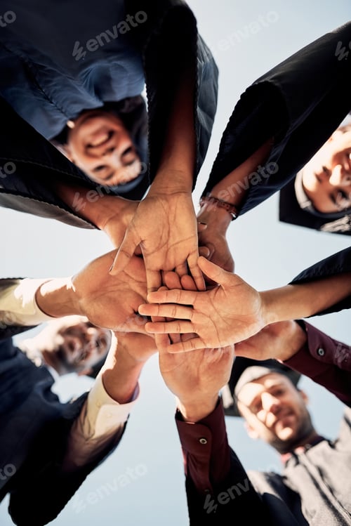 Preview: Closeup shot of a group of students joining their hands together on graduation day