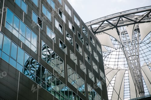 Preview: BERLIN, GERMANY - JUNE 20, 2017: low angle view of modern Sony Center, Potsdamer Platz and blue sky
