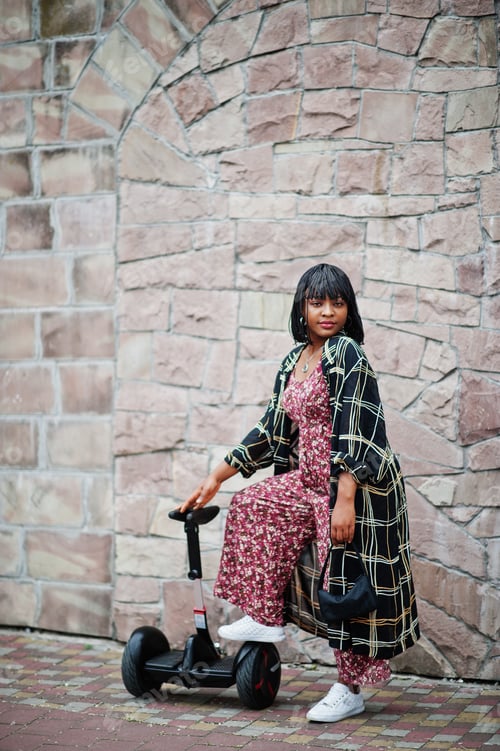 Preview: African american woman using segway or hoverboard