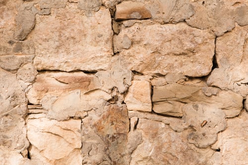 Preview: Masonry walls of natural sand color. Stone texture close-up, construction and mining background.