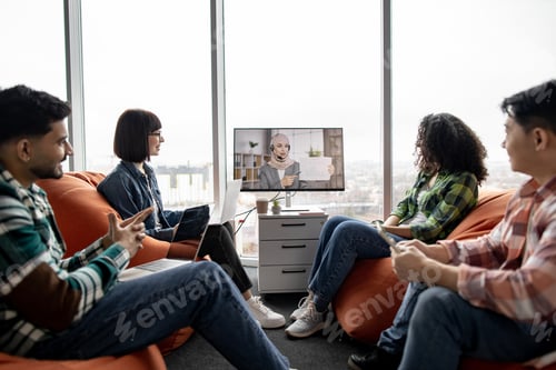 Preview: Entrepreneurs holding online briefing with colleague indoors
