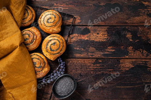 Preview: Sweet roll poppy seed buns with lavender ready for cooking. Wooden background. Top view. Copy space