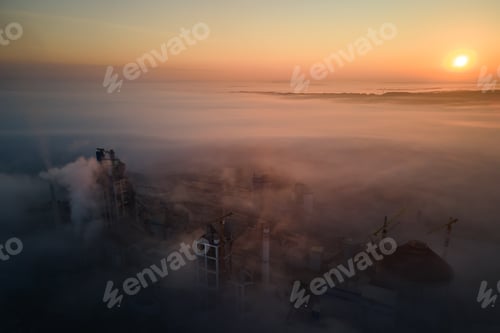 Preview: Aerial view of cement factory with high concrete plant structure and tower crane