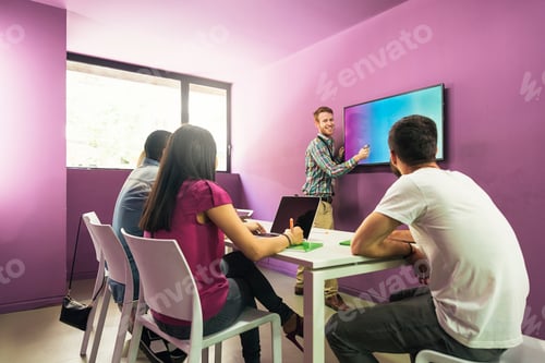 Preview: Teacher explaining the lesson to his students.