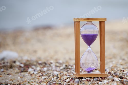 Preview: Close-up photo of wooden hourglass at the beach