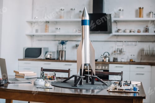 Preview: rocket model and tools for engineering on table in kitchen