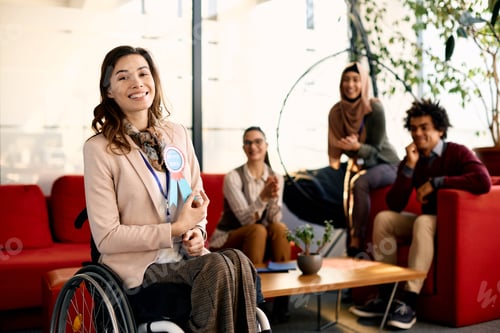 Preview: Portrait of happy disabled businesswoman with employee of the month badge in the office.