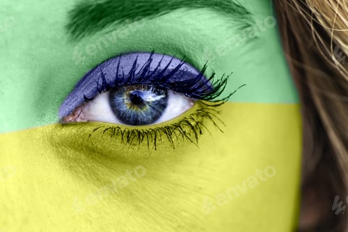 Preview: Closeup shot of a female's eye with the colors of the Brazilian flag