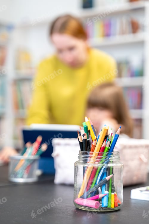 Preview: Glass jar filled with pencils sits on table during drawing lesson in library