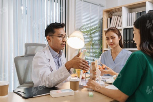 Preview: Doctor teaching medical team during a clinical session. Healthcare professionals learn together