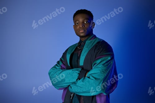 Preview: Stylish Black Man Posing Against Blue Background
