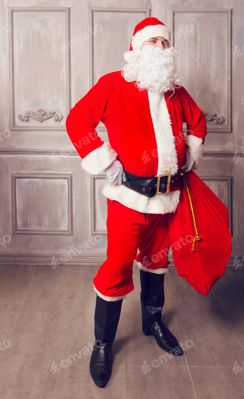 Preview: Photo of happy Santa Claus with big bag of presents
