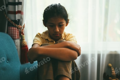 Preview: Upset girl hugging knees alone, Concept of lonely girl and kid with trouble