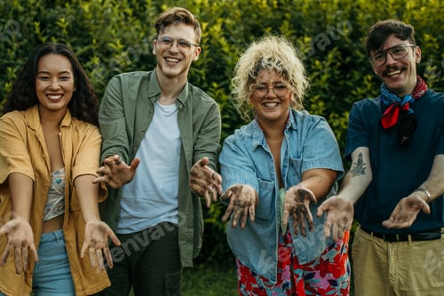 Preview: Diverse friends showing dirty hands after gardening teamwork