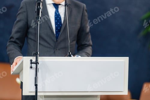 Preview: A confident speaker addressing the media during a press conference,