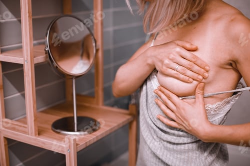 Preview: Woman checking her breasts