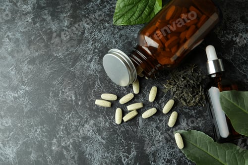 Preview: Concept of herbal medicine pills on black smokey table, space for text