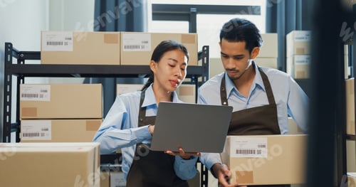 Preview: Asian business partner girl hold laptop and man wear formal shirt hold cardboard box training.