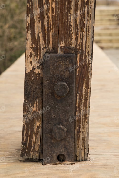 Preview: Rusty iron tie on a wooden beam
