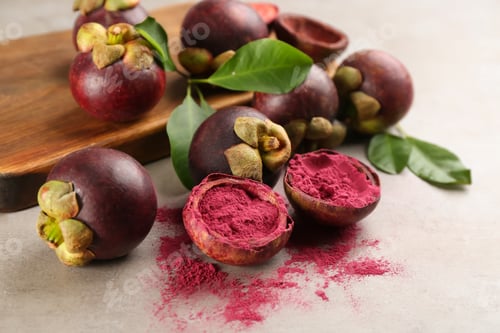 Preview: Purple mangosteen powder and fruits on light grey table