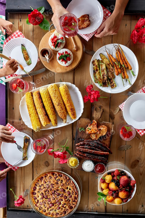 Preview: Top view over a dining table, decorated with flowers, family dinner.