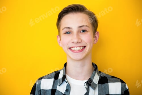 Preview: Close up portrait of a handsome teen boy, over a yellow background
