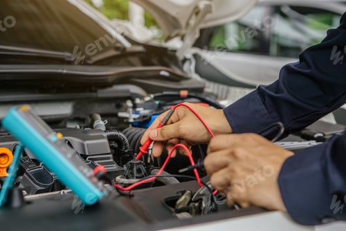 Preview: Mechanic man working on the engine of the car in the garage.